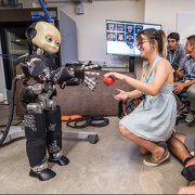 robotic child interacting with woman